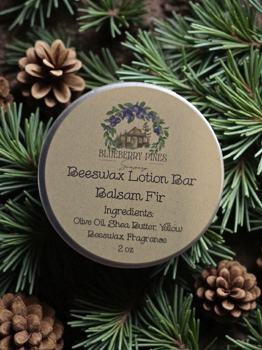 Beeswax lotion bar container with Balsam Fir fragrance on a green leafy background