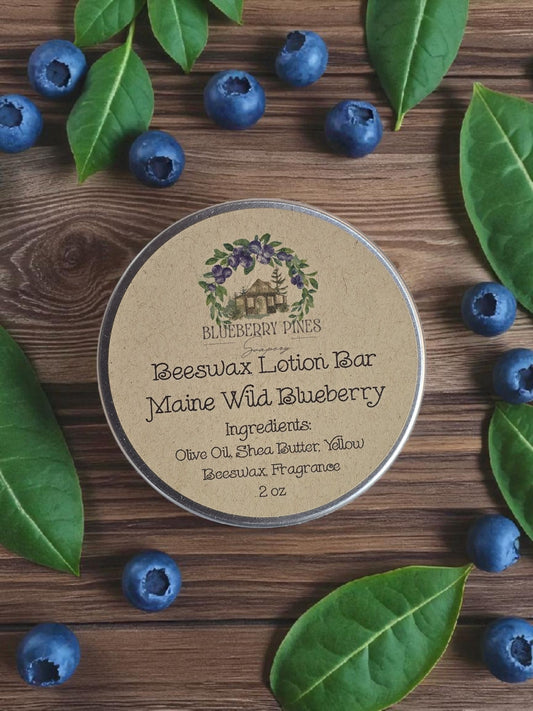 Beeswax lotion bar container with blueberries and leaves on a wooden surface