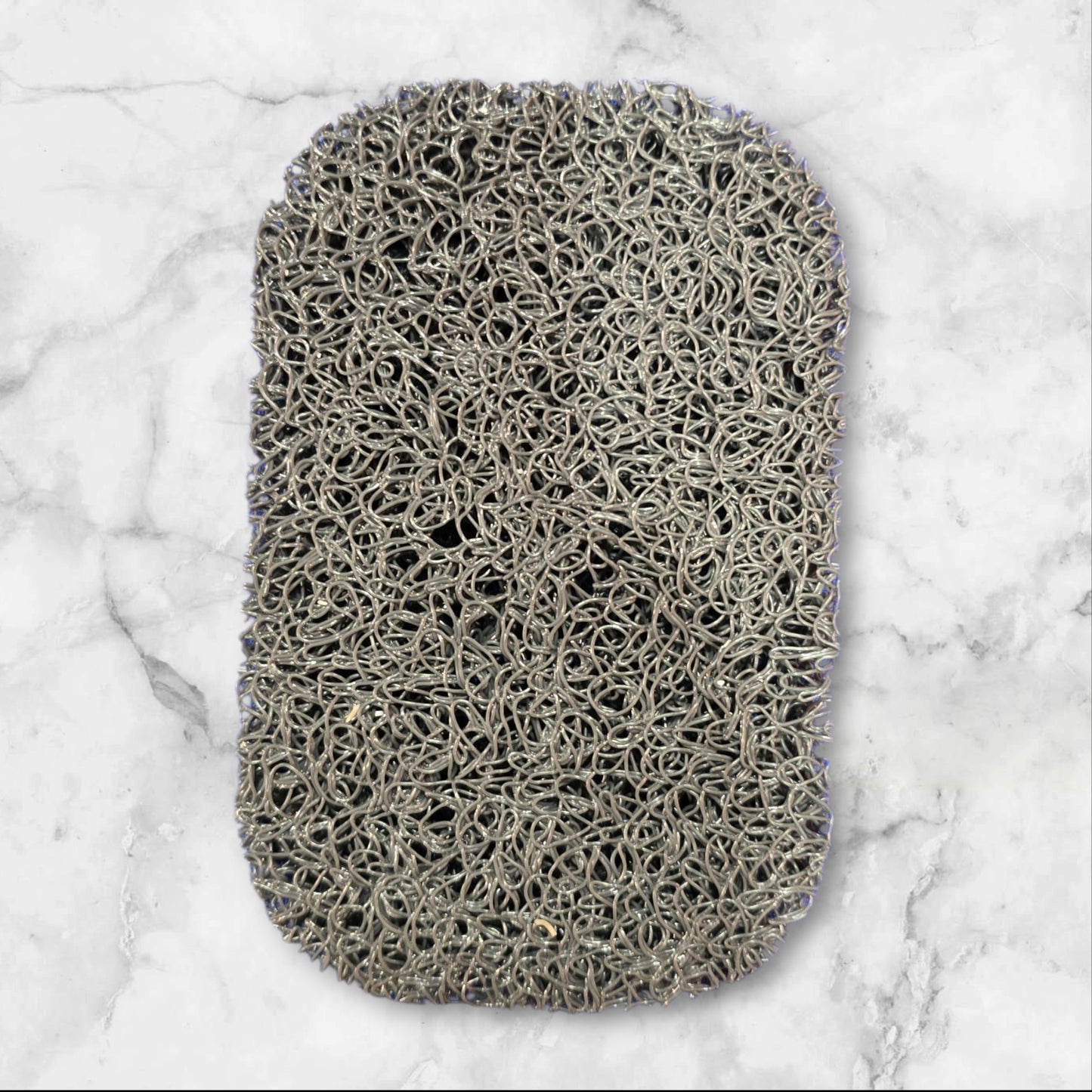 Non-slip self-draining soap bar holder pad that keeps bars dry, prevents slipping, and protects countertops.