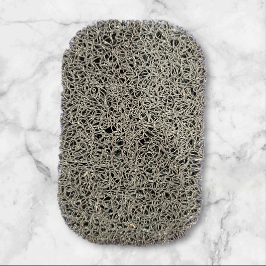 Non-slip self-draining soap bar holder pad that keeps bars dry, prevents slipping, and protects countertops.